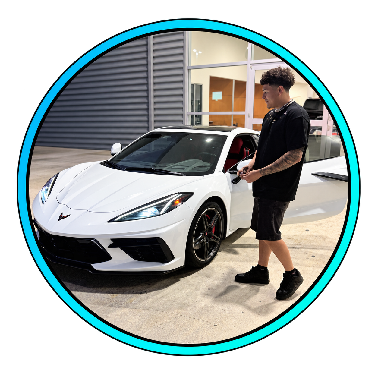 Aynjul beside his white Corvette
